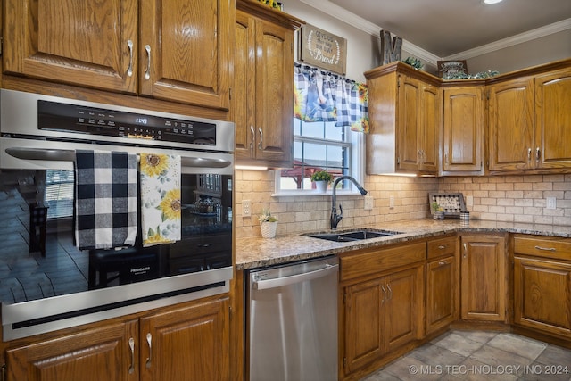 3691 E 390th Rd, Oologah, OK 74053 - kitchen with appliances with stainless steel finishes, a sink, brown cabinets, and ornamental molding