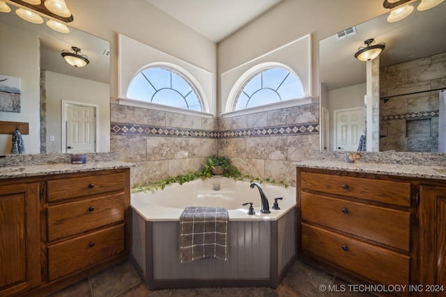 bathroom with tile walls, tile patterned flooring, and vanity