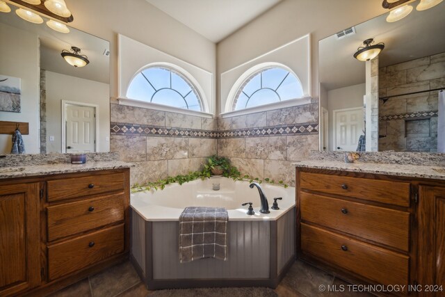 3691 E 390th Rd, Oologah, OK 74053 - full bath with two vanities, a garden tub, tile patterned flooring, and tile walls