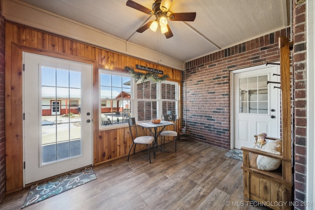 3691 E 390th Rd, Oologah, OK 74053 - sunroom / solarium featuring brick wall, wood finished floors, wood walls, and a wooden deck