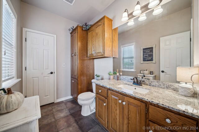 3691 E 390th Rd, Oologah, OK 74053 - bathroom with toilet, vanity, and baseboards