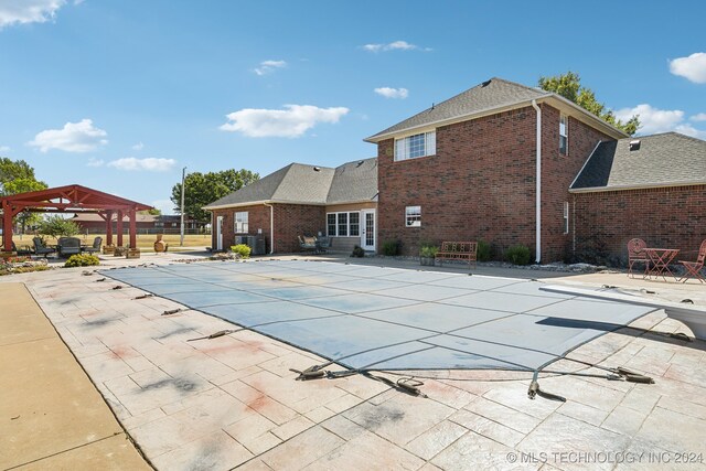 3691 E 390th Rd, Oologah, OK 74053 - view of swimming pool with a gazebo, a patio area, a covered pool, and a diving board