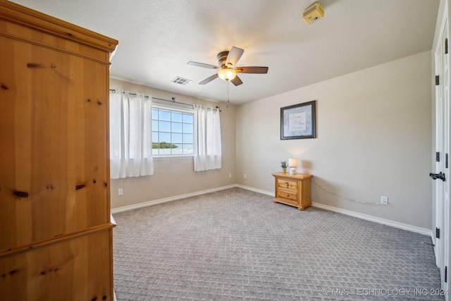 unfurnished bedroom with ceiling fan and carpet floors