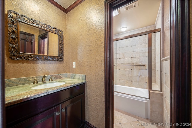 bathroom featuring crown molding, combined bath / shower with glass door, and vanity