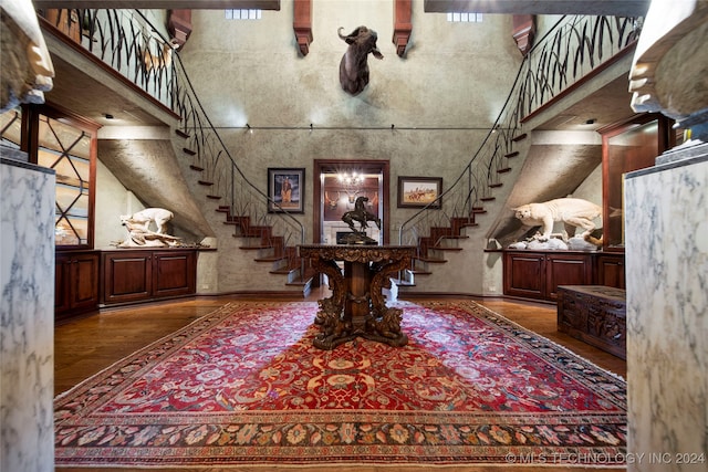 entrance foyer with a towering ceiling and hardwood / wood-style flooring