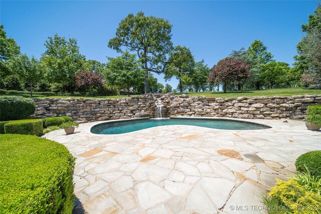 view of swimming pool featuring a patio and pool water feature