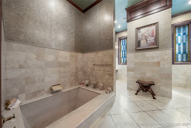 bathroom featuring tile walls, a bathing tub, and ornamental molding