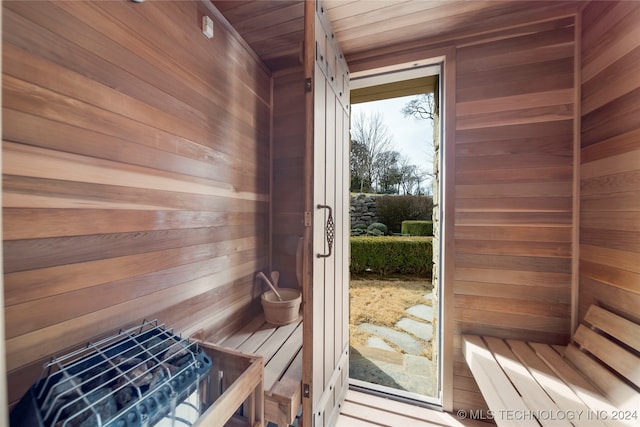 view of sauna featuring wooden ceiling and wood walls