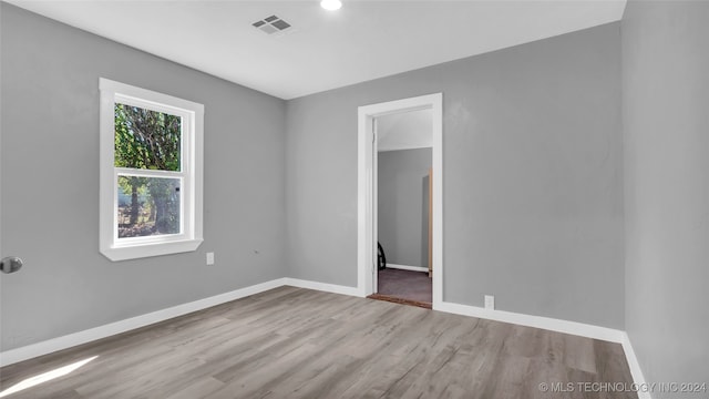 spare room featuring light wood-type flooring