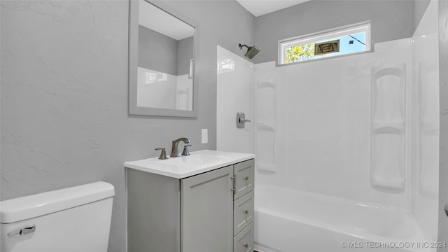 full bathroom featuring bathing tub / shower combination, vanity, and toilet