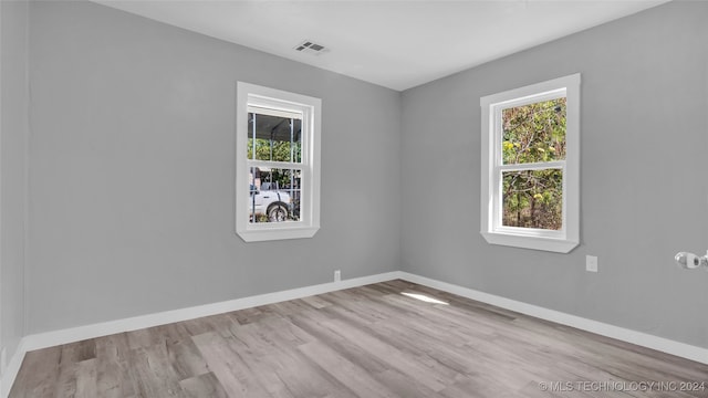 spare room featuring light hardwood / wood-style floors