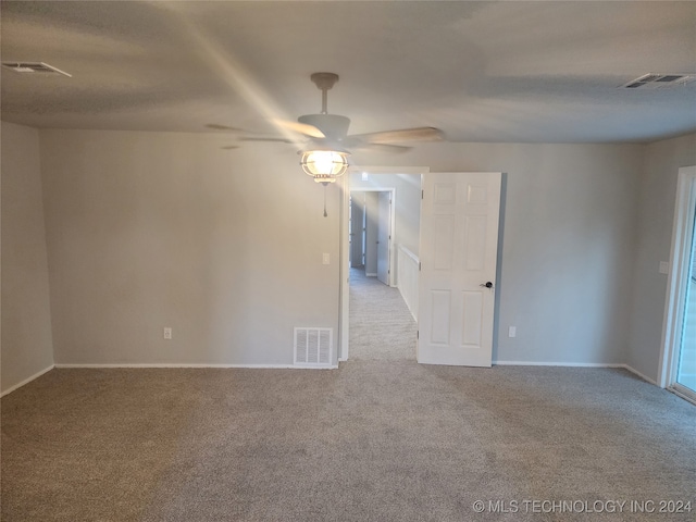 empty room featuring light carpet and ceiling fan