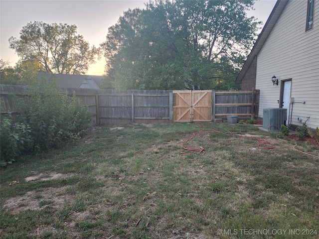 yard at dusk with cooling unit