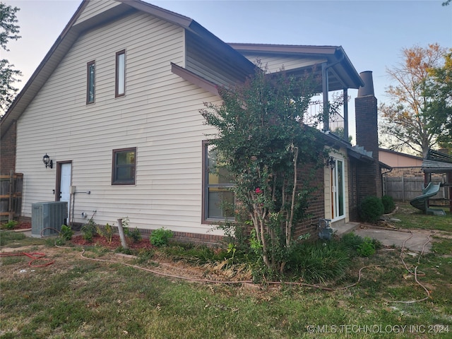 rear view of property with cooling unit