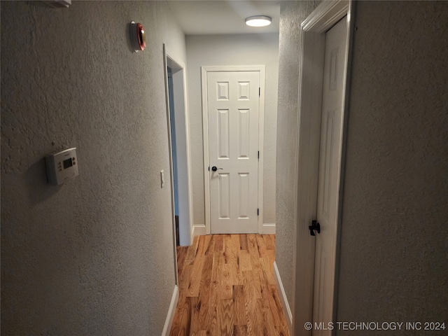 corridor with light hardwood / wood-style floors