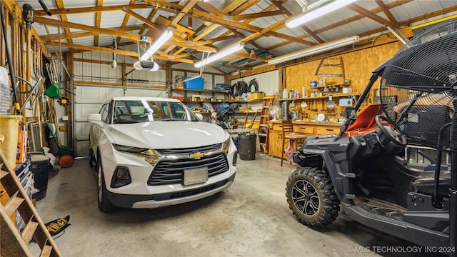 garage featuring a workshop area and a garage door opener