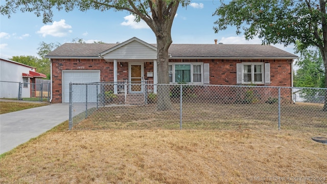 single story home with a garage and a front lawn