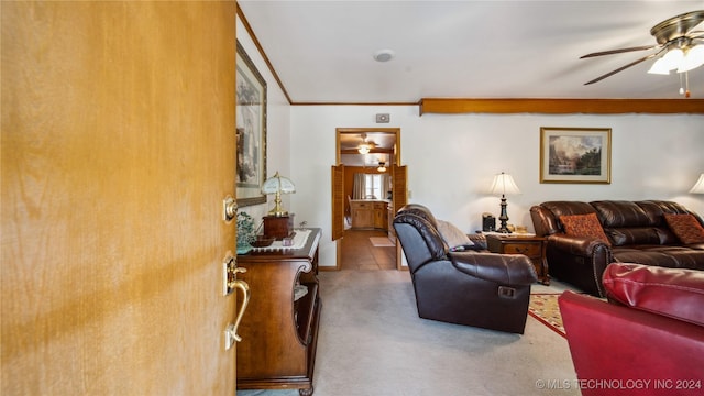 living room with ceiling fan, crown molding, and carpet floors