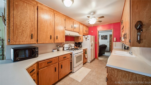 kitchen with white appliances, ceiling fan, and sink