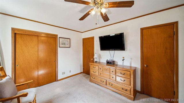 carpeted bedroom with ceiling fan and crown molding