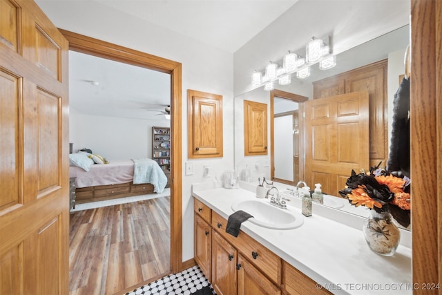 bathroom with vanity, hardwood / wood-style floors, and ceiling fan