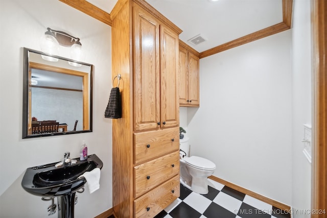 bathroom featuring crown molding and toilet