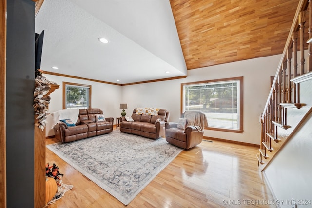 living room featuring light hardwood / wood-style flooring, lofted ceiling, and ornamental molding