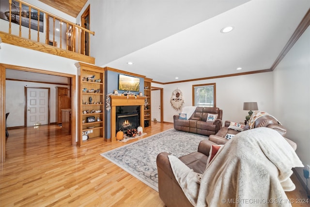 living room with hardwood / wood-style flooring and crown molding