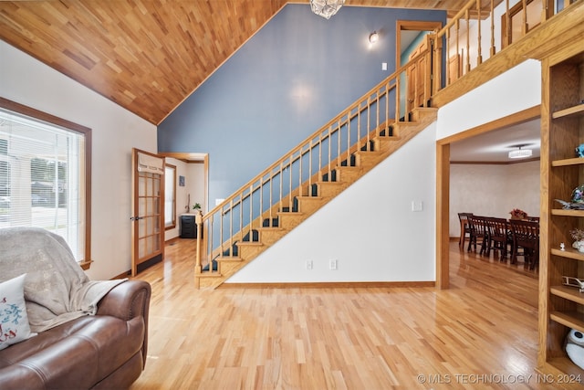 living room with wooden ceiling, light hardwood / wood-style floors, and high vaulted ceiling