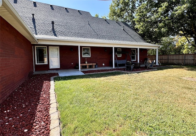 back of property featuring a lawn and a patio area