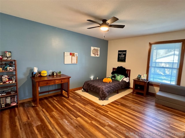 bedroom with a textured ceiling, dark hardwood / wood-style floors, and ceiling fan