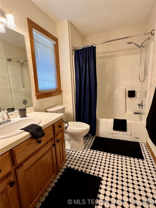 full bathroom with vanity, toilet, and shower / bath combo with shower curtain