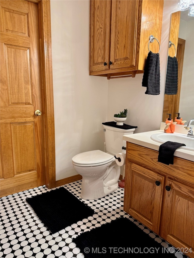 bathroom featuring vanity and toilet