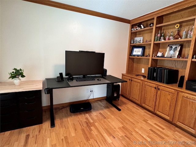 office area featuring light wood-type flooring and crown molding