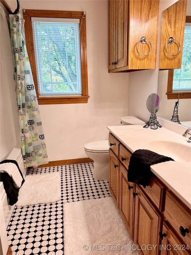 full bathroom with vanity, toilet, tile patterned floors, and shower / bath combination with curtain