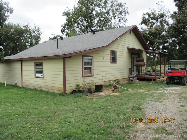 view of property exterior with a deck and a yard