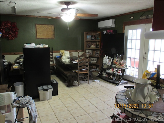 interior space with ceiling fan, light tile patterned floors, a textured ceiling, and a wall mounted air conditioner