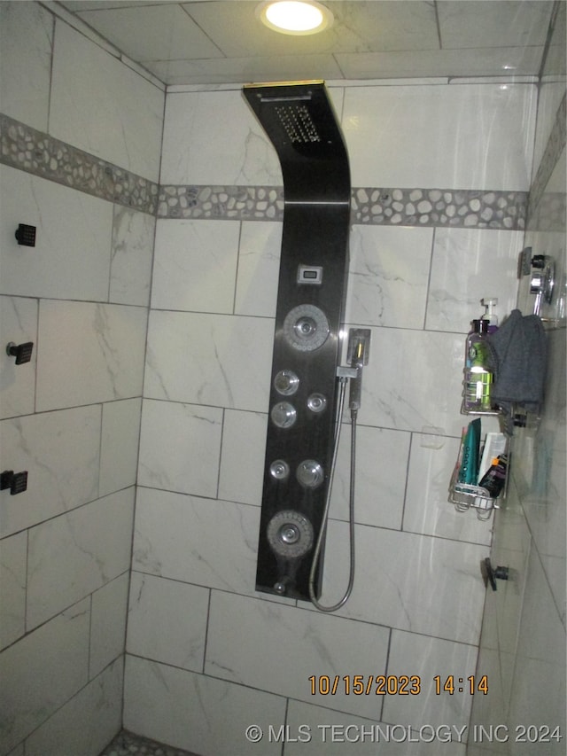 interior details with a tile shower