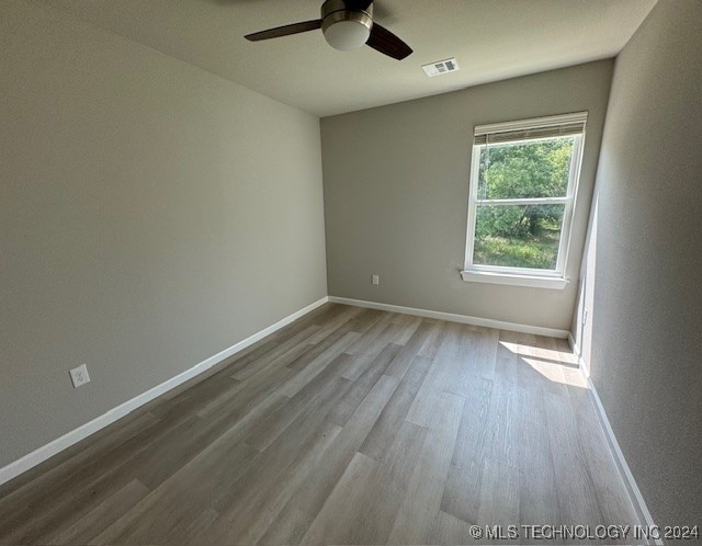 empty room featuring ceiling fan and light hardwood / wood-style flooring