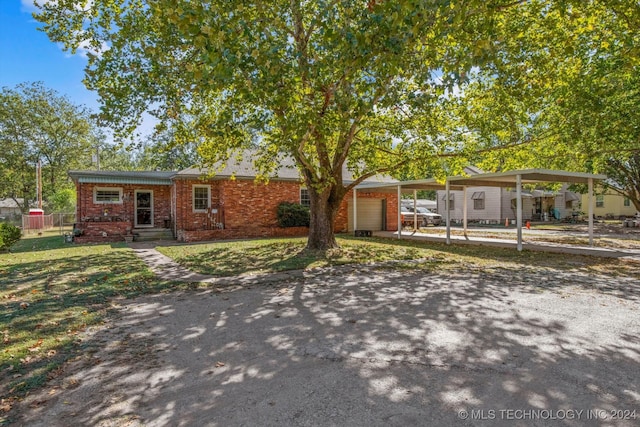 single story home featuring a carport and a garage