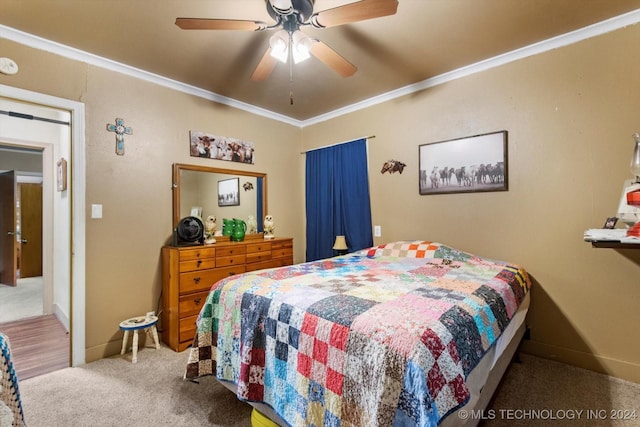 carpeted bedroom with ceiling fan and ornamental molding