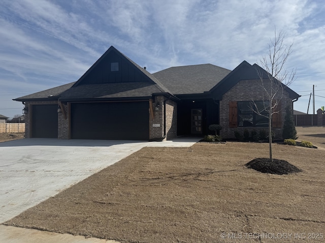 view of front of home featuring an attached garage, brick siding, a shingled roof, concrete driveway, and board and batten siding