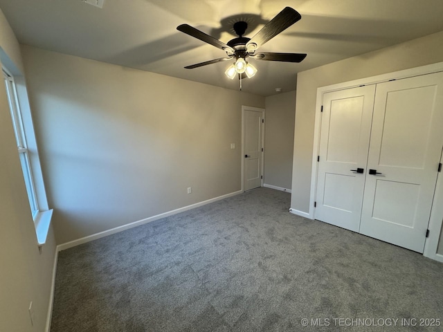 unfurnished bedroom featuring carpet floors, a closet, ceiling fan, and baseboards