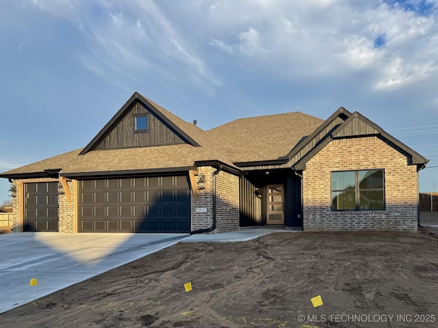 view of front of home featuring driveway, brick siding, and an attached garage