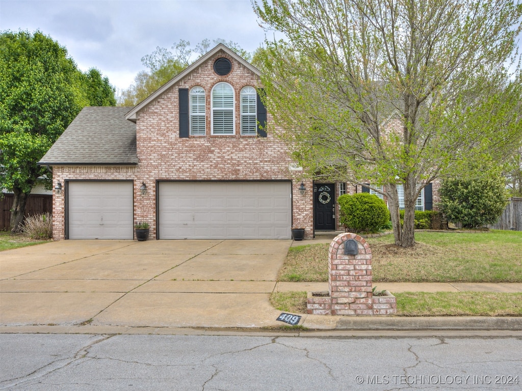 view of front property featuring a front yard and a garage