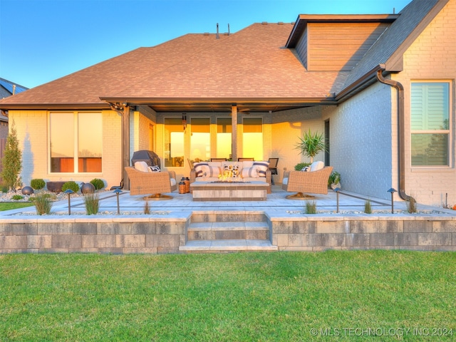 rear view of house featuring a lawn, outdoor lounge area, and a patio area