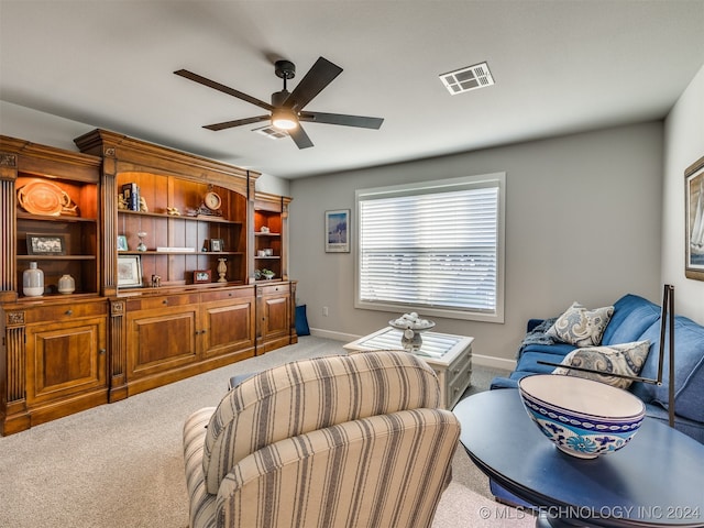 living room featuring carpet floors and ceiling fan