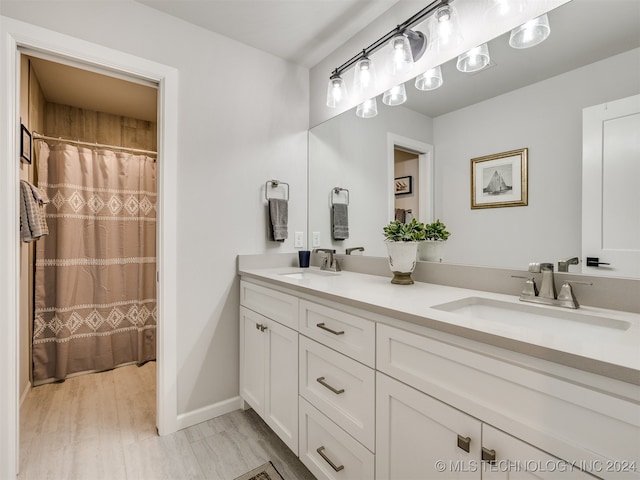 bathroom featuring hardwood / wood-style flooring and vanity