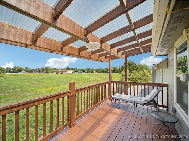 wooden terrace with a pergola and a lawn