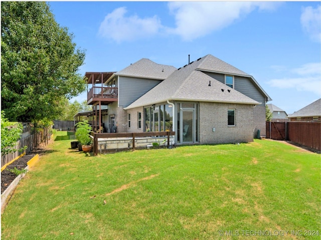 back of property with a yard, a fenced backyard, brick siding, and roof with shingles